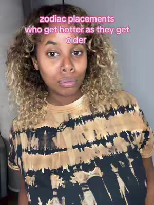 The cover image features a woman with curly, light brown hair with highlights, looking towards the camera with a neutral facial expression. She is wearing a tie-dye shirt in shades of brown and black. The background is a muted grey.