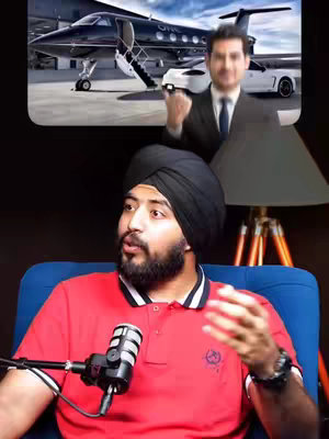 The image features a man in a red polo shirt and a black turban seated and talking to a microphone. Above him, a frame displays a luxury private jet and a man in a suit, suggesting a theme of wealth and business. The backdrop is a dark, styled setting.