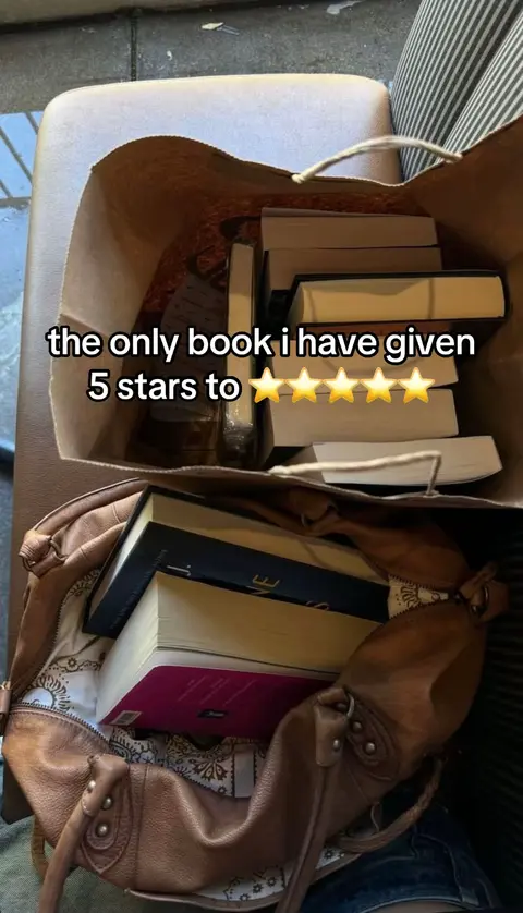 The image shows inside view of two bags. The top is a brown paper bag filled with books. The text overlay is written on the top of the bag. The bottom is a leather brown handbag. The books are visible and take up most of the visual space.