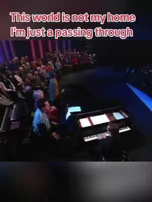 The cover image shows a stage with a person playing a piano in front of a crowd. The text overlay says, 'This world is not my home. I'm just passing through.'