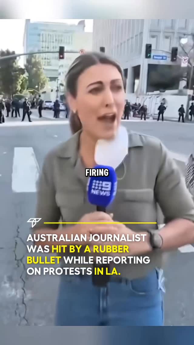 A woman speaks into a microphone on a city street, with additional large text elements overlaid at the bottom and top of the screen.