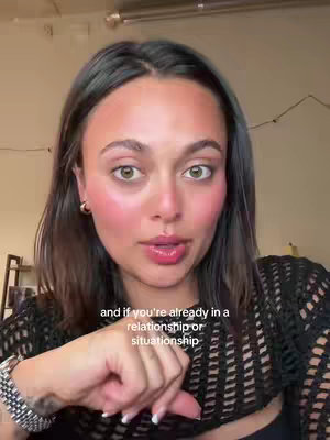 The cover image is a close-up shot of a woman looking directly at the camera with a neutral expression. She has dark hair, and subtle makeup highlighting her cheeks and lips. The background appears to be an indoor setting. The text overlayed near the bottom states, "and if you're already in a relationship or situation"