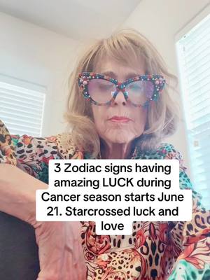 A selfie-style image featuring a woman wearing large, decorative glasses. She has blonde hair and is positioned indoors with a lightly blurred background. A text overlay with a white background and black text is positioned in the lower center of the image.