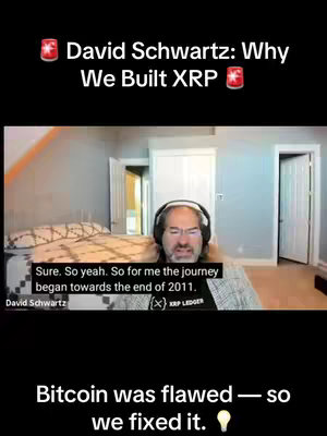 The cover image is a vertical video frame featuring a man in the middle of an indoor setting, likely a home office or study. At the top, above the man's head, are two red star icons and text that reads "David Schwartz: Why We Built XRP." The man is wearing glasses and a headset microphone. He's positioned in front of a background that includes a bed, a doorway, and a window, which indicates a room setting. Below the man, additional text reads, "Bitcoin was flawed — so we fixed it." and the text has a lightbulb icon.
