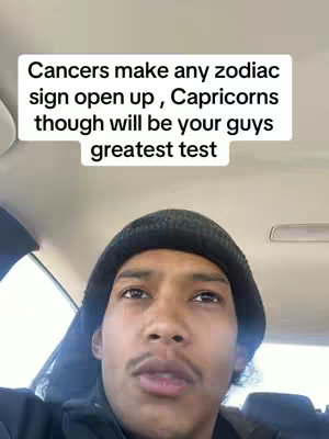 A man wearing a black beanie is positioned in the interior of a vehicle. Above him, a rectangular white text box contains overlaid text. The background features the car's headliner and other interior elements.