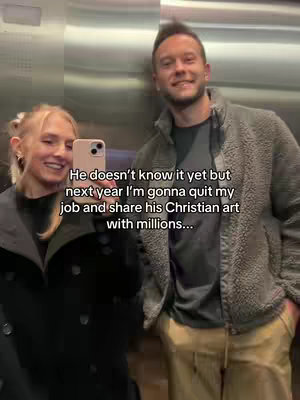 A selfie-style image taken in what appears to be an elevator. The woman on the left is smiling, holding a phone up to take a selfie.  Text overlays the image. The man on the right is also smiling. The overall composition suggests a casual, personal setting.