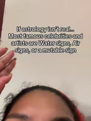 The cover image is a selfie-style shot, framing the top of a person's head and hand against a plain, off-white background. The person's dark hair and a red band are visible at the top of the frame. The person’s hand is in the left side of the frame. Overlayed on the image is white text in a sans-serif font, stating: "If astrology isn't real... Most famous celebrities and artists are Water signs, Air signs, or a mutable sign". The composition is simple, with the text clearly visible to the viewer.