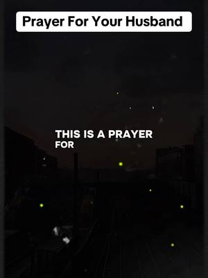 The image is a vertical shot with a dark, moody aesthetic. It features text overlays in white against a black background. The top text says 'Prayer For Your Husband' within a white rectangle, with a shadow. Below, the text 'THIS IS A PRAYER FOR' is displayed in a clean sans-serif font. The background appears to depict a city silhouette at night with bright lights and a dark sky with a few glowing particles. The overall impression is one of faith and reflection.