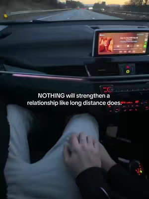 The cover image shows a point-of-view shot from inside a car driving on a highway. The focus is on the dashboard, the driver's hands holding another person's hands, and a digital display showing a music player. The light is dim, suggesting either twilight or night. Text overlay appears at the bottom, with a quote. The overall composition is intimate and calm.
