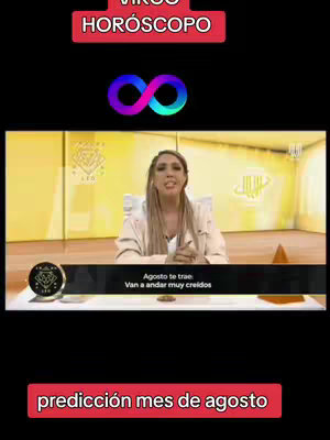 The cover image is a vertical video frame. On the top is a red banner with white text: 'VIRGO HOROSCOPO'. Below this is an infinity symbol in shades of blue and purple. The main portion of the image shows a woman with long blonde hair, wearing a light-colored jacket, speaking from what appears to be a television studio setting. There's a lower text strip in black with white text discussing predictions, and a red bar at the bottom with the text 'predicción mes de agosto'. The backdrop is a golden tone with arabic calligraphy.