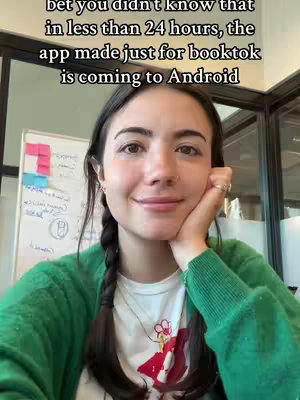 A woman in a green cardigan and white t-shirt with a design is looking at the camera and smiling. She has her left hand under her chin. Overlaid text in black is at the top of the image.