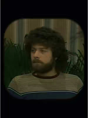 The image is a retro-style portrait. The main subject, a man with curly brown hair and a beard, is framed inside an oval. He wears a striped shirt. The background appears to be a room with vertical striped wallpaper and some greenery.