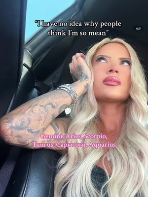 A woman with long blonde hair, dark roots, and heavy makeup looks up thoughtfully while resting her hand on her face. The background appears to be inside a car. Overlaid text includes a quote and a list of zodiac signs.
