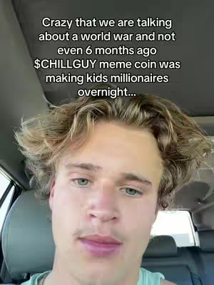 A selfie-style shot taken from inside a car. The main focus is on a young man with light-colored hair, looking directly at the camera. The background shows a car interior.
