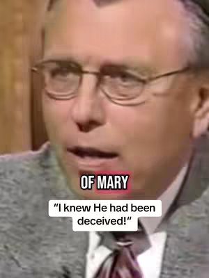 A close-up shot of an older man with glasses, wearing a gray sweater and a patterned tie. Text overlays are present, with the words 'OF MARY' above and a quote below.