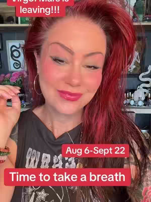 The cover image features a woman with red hair and makeup, looking at the camera. Text overlays indicate astrological predictions.