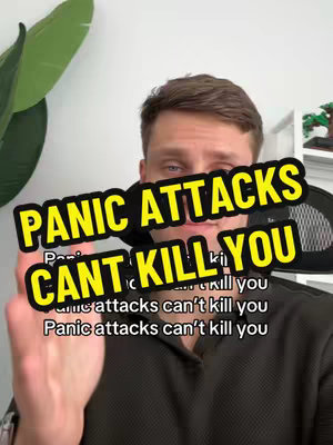A man with short brown hair is centered, framed from the chest up, set against a simple background. The main element is a prominent text overlay in a bold yellow-and-black banner that reads "PANIC ATTACKS CANT KILL YOU", overlaid on the man's image. Below it, more text is partially visible. There are plants in the background and the man is making a hand gesture.