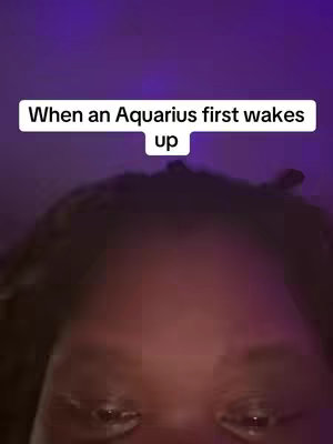 The cover image shows a close-up of a person's face, focusing on their eyes. The background is a gradient of dark purple. Text on a white rectangular label reads, 'When an Aquarius first wakes up'.