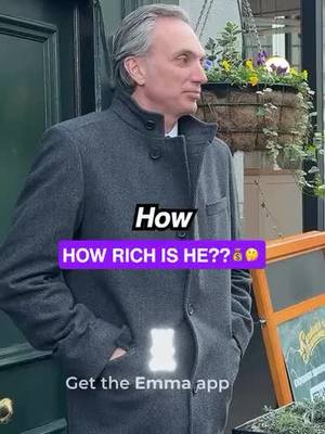 A cover image featuring a man in a gray coat standing outdoors in front of a door. In front of him are overlaid text elements including the question 'HOW RICH IS HE??'. The man has grey hair and is looking to his right. In the background are hints of shops and plants.
