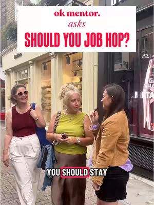 Three women stand outside a shop, apparently in discussion. A text overlay asks if one should job hop, answered that one should stay.