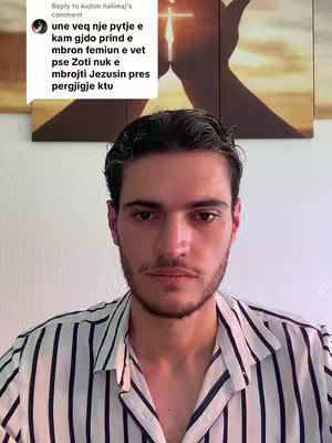 A man is centered in the frame, looking directly at the viewer with a neutral expression. He has dark hair and a beard. He's wearing a striped button-down shirt. Behind him, there’s a blurred background with what appears to be a cross or a religious symbol illuminated by sunlight. The comments above show a question as a hook.