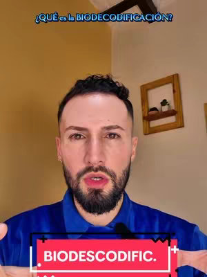 The cover image features a close-up of a man with a beard, in front of a warm-toned wall. The man is looking towards the camera as if speaking, with text overlayed at the top which reads '¿QUÉ es la BIODECODIFICACIÓN?' (What is BIODECODIFICACION?). A colored rectangular text element at the bottom declares 'BIODESCODIFIC'. The background includes a wooden object and a golden surface.