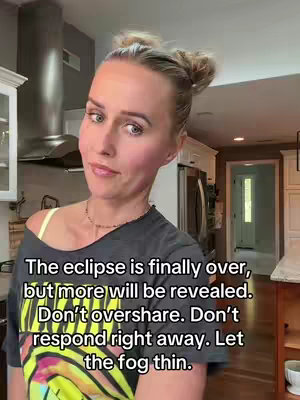 The cover image is a selfie of a woman standing in what appears to be a home setting. The woman has blonde hair pulled up in a bun, fair skin, and is wearing a dark t-shirt with a colorful graphic. The background features what looks like a kitchen with cabinets, a stainless steel range hood above a stove, and a doorway leading to another room. The lighting is bright, and her expression is neutral with a slight smile. The text overlay is added in black.