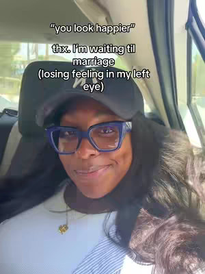 A woman with long black hair is sitting in a car, looking at the camera and smiling slightly. She's wearing a black hat, large blue-framed glasses, and a white shirt. Text overlays the image in a casual, friendly font.