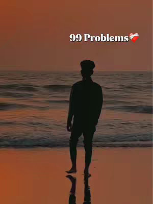 The image shows a lone figure standing on a beach, facing away from the camera, silhouetted against a colorful sunset. The text '99 Problems' is superimposed, with a heart emoji next to it. The overall composition evokes a sense of solitude and reflection.