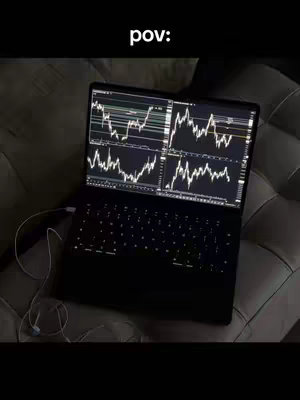 A laptop displaying trading charts is open on a dark surface, likely a bed. The screen shows multiple graphs with fluctuating lines. Overlaid on the top of the image is the text 'pov:'. Earphones are connected to the laptop.