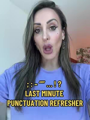 A woman with long brown hair and a light blue t-shirt is shown making a surprised face. Text overlayed on top of the image includes punctuation, exclamation points, and the words 'LAST MINUTE PUNCTUATION REFRESHER'. The background is blurred.