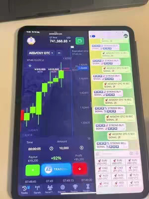 The cover image displays a tablet divided into two sections. On the left, a trading platform application interface shows a candlestick chart with green and red bars indicating price movements. Financial data such as time, amount, and profit are also visible. The right side displays a messaging application, resembling WhatsApp, filled with several messages. These messages appear to be signals, containing recommendations to "BUY" or "SELL" a specific currency pair by a bot. The overall composition highlights real-time financial data and signals for trading.