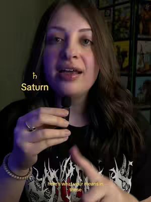 A woman with brown hair and a black t-shirt with a design is holding a microphone and speaking. Overlay text and graphics explain astrological concepts, with background elements including a bookshelf and decorative art.