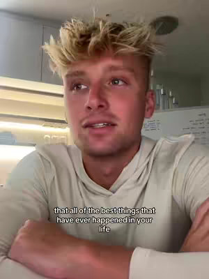 A young man with blonde, spiky hair is centered in the frame, looking towards the left. He's wearing a light-colored, long-sleeved shirt. Text overlayed on the bottom provides a quote.