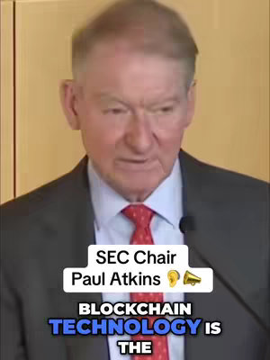 A man in a suit and tie is centered, speaking. Text overlays identify him as Paul Atkins, SEC Chair, along with a tagline regarding blockchain technology. The background is a simple wall.