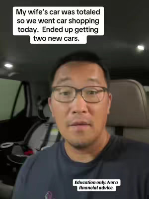 A man in glasses is recording a selfie-style video from inside a car. Above his head are the words "My wife's car was totaled so we went car shopping today. Ended up getting two new cars." Below, the text "Education only. Not a financial advice."