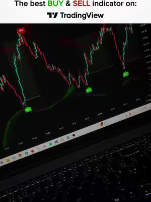 A laptop screen displays a trading chart with green and red lines, representing price fluctuations. The text at the top highlights the buy and sell indicator on the TradingView platform. A dark background and visible keyboard provide context.