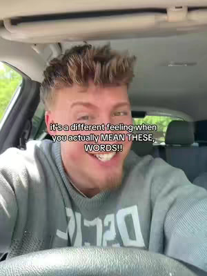 The cover image shows a man inside a car, seen from the chest up. He is smiling widely, and text overlayed on the image reads a sentence. The interior of the car and the outside environment are slightly visible in the background.