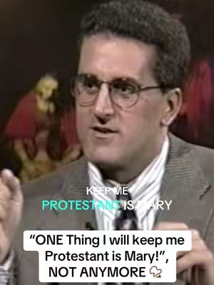 A man in a blazer and glasses speaks in front of a blurred background, with superimposed text saying his views on Mary.