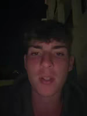 The cover image features a close-up of a young man's face. He is looking towards the viewer and talking. The background is dark, suggesting a dimly lit or indoor setting. The man has short, dark hair, and his complexion is fair with a slight flush, suggesting that he might be in a warm environment.