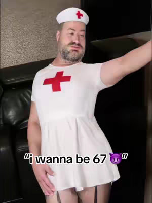 The cover image features a man dressed in a white nurse's uniform with a red cross on the chest and cap. The man has a beard and is holding himself and gesturing to the side near an interior background.
