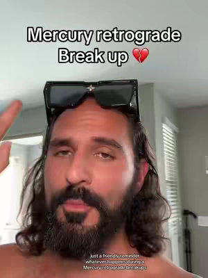 A man with a beard and sunglasses perched on his head, appears to be indoors. Text overlays state 'Mercury retrograde' and 'Break up' with a broken heart emoji.