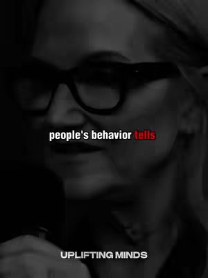 A black and white image showing a person wearing glasses looking downwards with text overlays. The image uses high contrast to emphasize the subject.