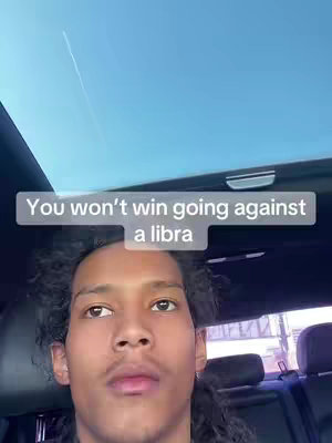 A selfie captured from inside a car, featuring a young man with curly hair and a neutral expression, set against a backdrop of a blue sky peeking through the car's sunroof. A light-colored, horizontal text bar overlays the image, positioned above the individual's head.