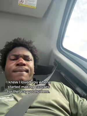 The cover image shows a close-up of a Black man's face, seen from a low angle inside a vehicle. He wears a greenish-yellow shirt and has short, textured, dark hair. A seatbelt is visible, and the right side of the frame includes the car's window and interior. The background has a neutral color and there is text overlaid at the bottom.
