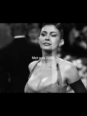 A black and white photo features a woman, likely a celebrity, facing slightly to the side. Her hair is styled up, and she is wearing an elaborate earring. The text "Met gala 2025." is overlaid at the bottom of the image.
