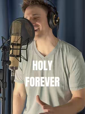 The cover image shows a man wearing headphones and a microphone in front of him. The front of his shirt has the words "Holy Forever" in a large white font.