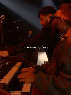 The cover image shows a dimly lit performance space with two men in the foreground. One is playing an organ, while the other stands beside him, both dressed in dark attire. The phrase, 'I know He's right here,' is overlaid on the image in white text.