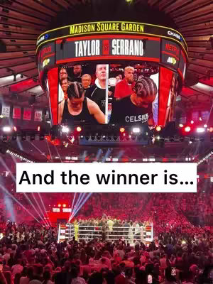 Image captures a boxing match at Madison Square Garden, focused on a large screen displaying 'TAYLOR vs SERRANO'. Below, a ring is visible, surrounded by a crowd. The composition is a wide shot, capturing the energy of the event.