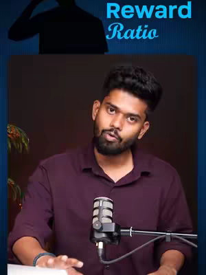A man in a maroon shirt is looking at the camera, holding a microphone. The background is dark, with a text overlay that says "Reward Ratio" and an image of a person in the top left corner.